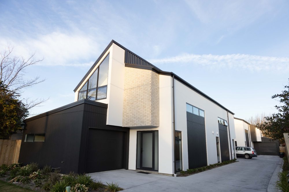 Two-storey black and white townhouses on Milton Street