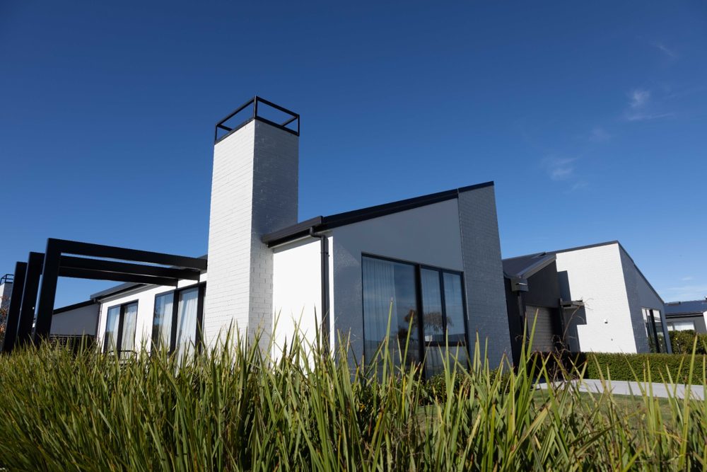 Contemporary white villa with chimney at Silverstream Retirement Village